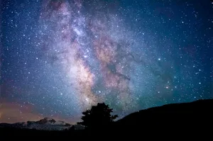 silhouette of trees and mountain under blue sky at nighttime jigsaw puzzle
