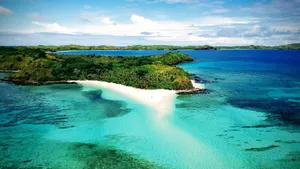 a beach with blue water and green land jigsaw puzzle