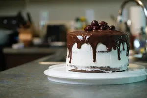 a cake with chocolate icing and cherries on a plate jigsaw puzzle