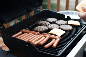 person standing in front grill grilling sausage jigsaw puzzle