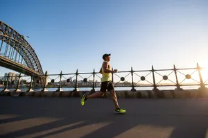 man in yellow tank top running near shore jigsaw puzzle
