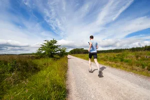man running on road near grass field jigsaw puzzle