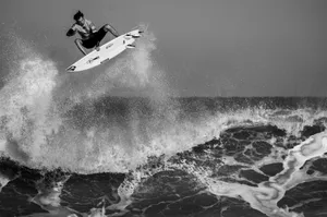 grayscale man surfing jigsaw puzzle