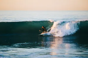 man surfing on ocean wave during daytime jigsaw puzzle