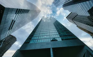 low angle photography of high rise building under white clouds during daytime jigsaw puzzle