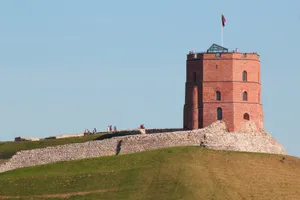 a tall brick tower sitting on top of a lush green hillside jigsaw puzzle