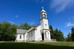a white church with a cross on top of it jigsaw puzzle