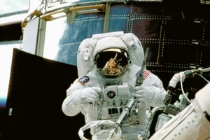 a man in a space suit standing in front of a space station jigsaw puzzle