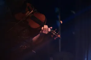 person playing violin during nighttime jigsaw puzzle