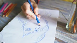 Hand sketching a portrait with a blue pencil. jigsaw puzzle