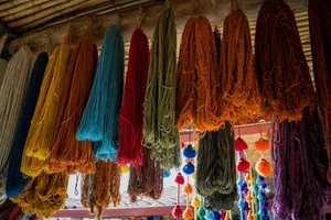 a bunch of different colors of yarn hanging from a ceiling jigsaw puzzle