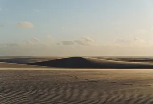Captivating view of São Luís sand dunes under a warm sunset sky. jigsaw puzzle