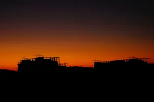 A breathtaking view of urban silhouettes against a vibrant orange sunset. jigsaw puzzle