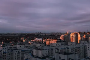 Aerial view of Kyiv city with striking clouds and sunset light over the urban skyline. jigsaw puzzle