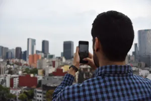 Man photographing urban cityscape with smartphone against skyline. jigsaw puzzle