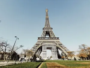 Low angle shot of the Eiffel Tower in Paris with blue sky and partial park view. jigsaw puzzle