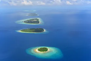 Stunning aerial shot of a chain of tropical islands in the Maldives surrounded by turquoise waters. jigsaw puzzle