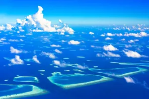 Stunning aerial view of a tropical archipelago with turquoise waters and scattered clouds. jigsaw puzzle