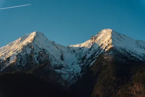 Experience the serene beauty of the snow-capped mountains in Żdiar, Slovakia under the soft glow of the sunset. jigsaw puzzle