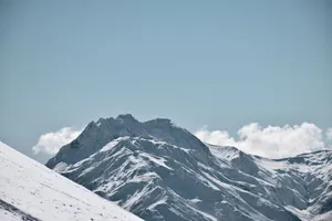 Majestic snow-covered mountains under a clear blue sky, showcasing winter's beauty. jigsaw puzzle