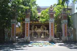 Intricately decorated Asian temple entrance with colorful columns and lush greenery. jigsaw puzzle