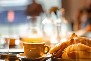 Warm and inviting café scene featuring a cup of coffee and croissants. Perfect for breakfast vibes. jigsaw puzzle