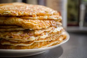 Close-up of delicious homemade pancakes stacked high on a plate, perfect for breakfast. jigsaw puzzle