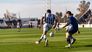 Players in action on the soccer field during an outdoor match under the bright sun. jigsaw puzzle