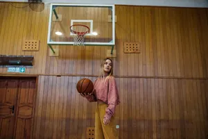 Woman holding a basketball on an indoor court, ready for the game. jigsaw puzzle