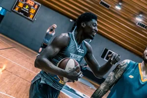 Engaging moment of basketball players during an indoor training session on a wooden court. jigsaw puzzle