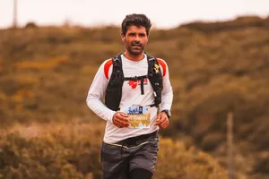 Trail runner with determination competing in an outdoor marathon event. jigsaw puzzle
