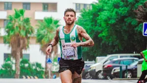 Tattooed male runner participating in a marathon, showing dedication and endurance on a rainy day. jigsaw puzzle