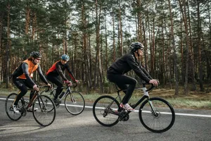 Three cyclists enjoying a ride through a scenic forest on a sunny day. jigsaw puzzle