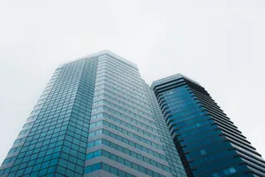 Low angle view of modern skyscrapers in Hong Kong against a cloudy sky, showcasing architectural design. jigsaw puzzle