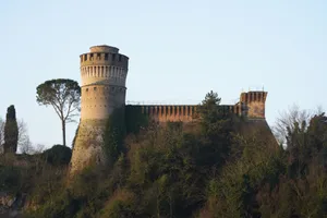 A captivating view of a historic castle with a prominent tower amidst lush greenery. jigsaw puzzle