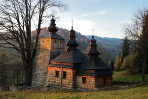 Captivating view of a historic wooden church in Dubne, Poland during a serene sunset. jigsaw puzzle