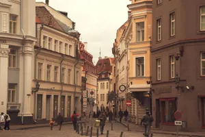A bustling street scene in Tallinn's Old Town, featuring historic architecture and pedestrians in autumn. jigsaw puzzle