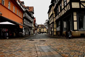 Historic European street with half-timbered houses under an overcast sky, capturing old-world charm. jigsaw puzzle