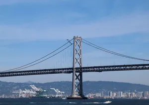 Scenic view of the Bay Bridge with San Francisco cityscape and water in the foreground. jigsaw puzzle