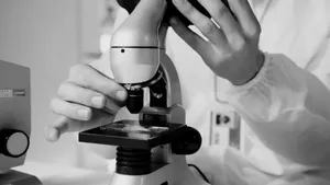 A scientist in a lab coat using a microscope for research in a laboratory setting. jigsaw puzzle