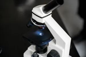 Close-up view of a laboratory microscope with selective focus, ideal for scientific use. jigsaw puzzle