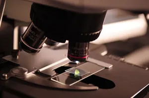 Detailed view of a microscope with a slide in a laboratory environment. jigsaw puzzle