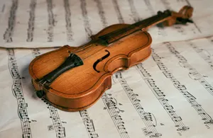 Close-up of a vintage violin resting on sheet music, highlighting the beauty of classical music. jigsaw puzzle