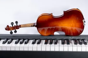 A polished violin rests on a digital piano keyboard against a white background. jigsaw puzzle