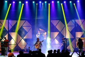 Energetic live band performance on stage with dynamic lighting at night. jigsaw puzzle