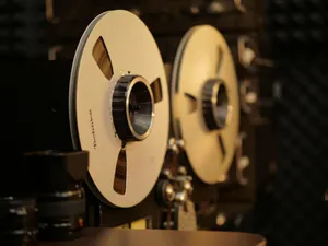 Close-up of a vintage reel-to-reel tape recorder in a professional audio recording studio. jigsaw puzzle