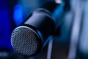 Detailed close-up of a professional studio microphone with a blurred blue background. jigsaw puzzle