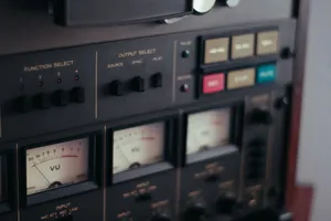 Close-up view of a vintage tape recorder showcasing VU meters and control knobs. jigsaw puzzle