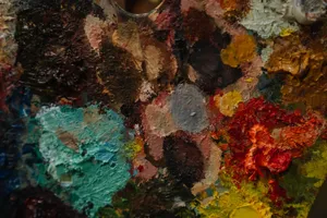 Close-up of a colorful artist's palette with various paint blobs and textures. jigsaw puzzle