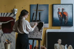 A woman artist paints in a creative studio surrounded by various artworks and tools. jigsaw puzzle